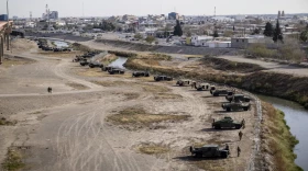 Texas National Guard position themselves on the banks of the Rio Grande, Tuesday, Dec. 20, 2022, in El Paso.