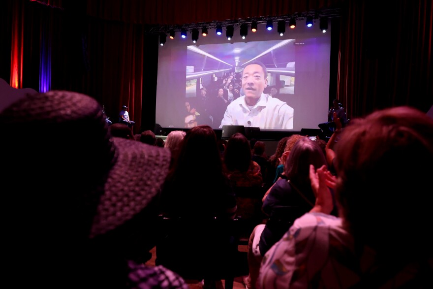 State Rep. Gene Wu, D-Houston, calls in to Beto O'Rourke's "The People vs. The Power Grab" rally at the Ridglea Theater in Fort Worth on Aug. 9, 2025. Wu and other Texas House Democrats fled the state to stop a GOP-led vote on redistricting.