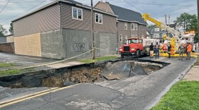 A large sinkhole opened Wednesday afternoon, June 25 on Horton Street in Wilkes-Barre. Officials believe stormwater may have been the cause. The water tanker at right partially fell into the hole and needed to be towed out.