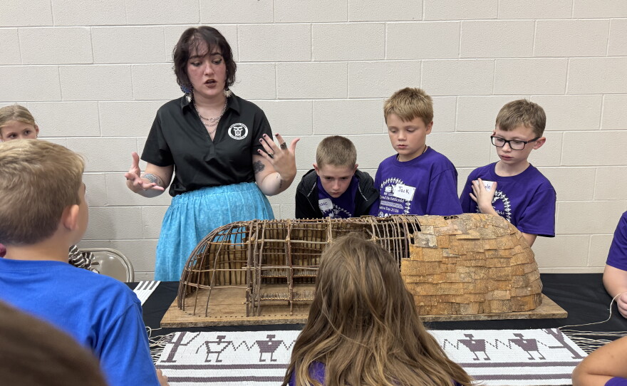 Cultural assistant with the Wyandotte Nation Cultural Center Ciara Cotter shows students a model of a longhouse her ancestors would have lived in.