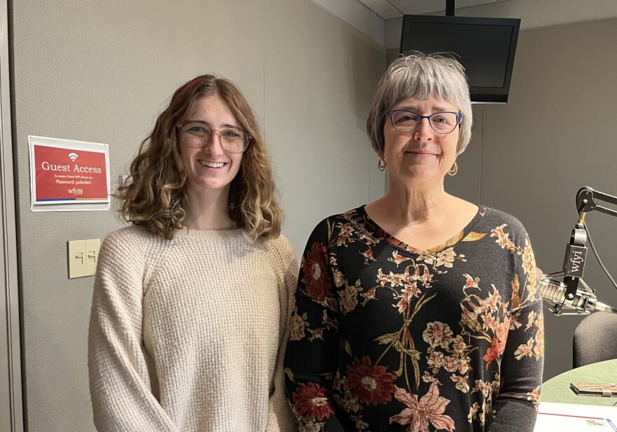 Aubrey Miles, an intern at the Benjamin Harrison Presidential Site and Jennifer Capps, VP of exhibition and curatorship, share some of the new artifacts on exhibit. (Jill Sheridan WFYI)