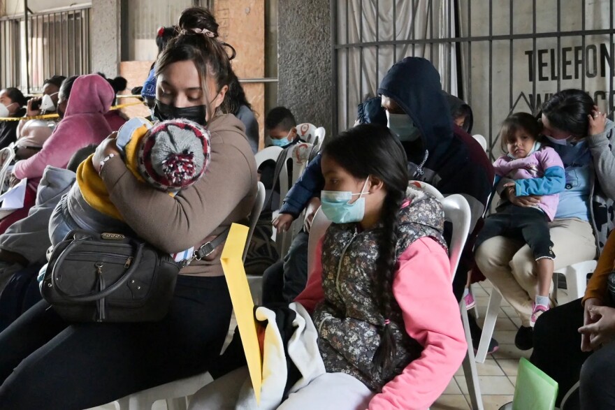 Migrants line up to get health services near the free non-profit clinic in Tijuana, Mexico on Dec. 22, 2022.