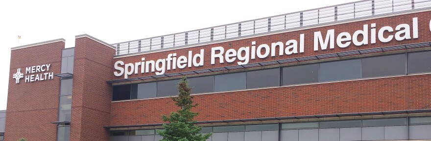 A brick building that's the Springfield Regional Medical Center, with a tree in the foreground.