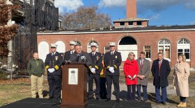 Officials gather outside the Tesla Science Center.