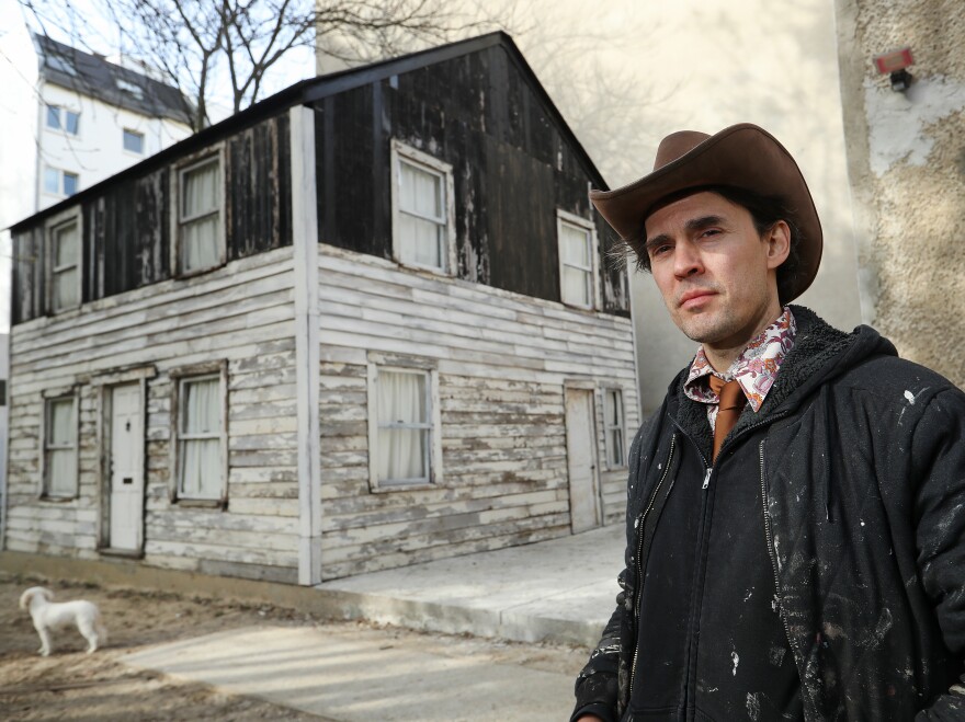 U.S. artist Ryan Mendoza poses for a photo next to the former house of Afro-American human rights figure Rosa Parks on Mendoza's property on April 6, 2017 in Berlin, Germany. Mendoza bought the house, which was slated for demolition in Detroit, took it apart, shipped it to Germany, and put it back together again on the property next to his studio.