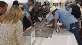 People study graphics depicting proposed changes to U.S. Highway 380 at a public meeting in Princeton on May 9.
