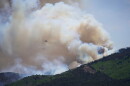 A helicopter flies near the Cottonwood Fire in Beaver, Utah, Tuesday, June 30, 2026. (AP Photo/Ty ONeil)