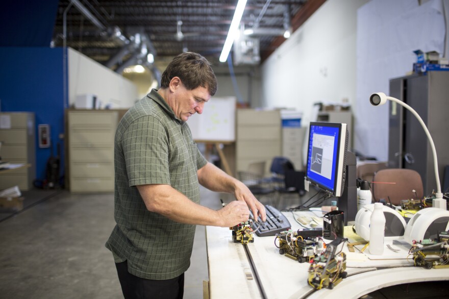 Taxi 2000 is a Minneapolis firm developing the SkyWeb Express system, a point-to-point personal rapid transit system. Here, company CEO Mike Lester works in the company's warehouse in Fridley, Minn.