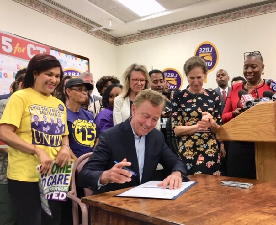 Gov. Ned Lamont signs the $15 minimum wage bill in 2019.
