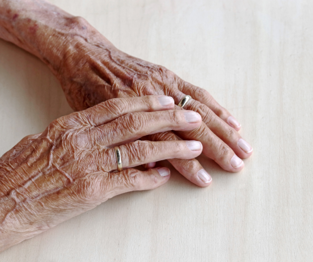 Two people hold hands.