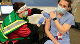 Dr. Casey Frey receives a COVID-19 vaccine in mid-December. On Jan. 21, state health officials announced they would not yet expand vaccine eligibility to the next age group.