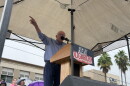 Man gesturing under a tent