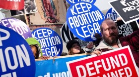 Activists on both sides of the abortion issue attend a vigil outside the U.S. Supreme Court on Jan. 23. The vigil was held to mark the anniversary of the <em>Roe v. Wade</em> Supreme Court decision that legalized abortion. Anti-abortion groups plan to push several bills this year that would restrict abortions.