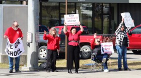 People wave signs in support of Sterling Elelmentary School at the intersection of the Kenai Spur and Sterling highways on Saturday, May 3, 2025 in Soldotna, Alaska. The school is slated for closure under a budget adopted by Kenai Peninsula Borough School District school board members.