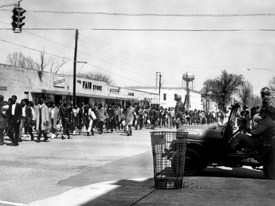 Civil rights demonstrators pass by federal guards as they make their way from Selma to Montgomery in 1965, on the third leg of their famous march.