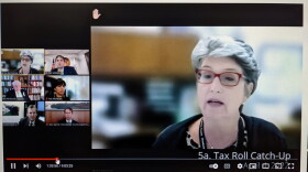 A YouTube meeting screen. On the right, in large view, a woman gives a presentation to five people in smaller view.