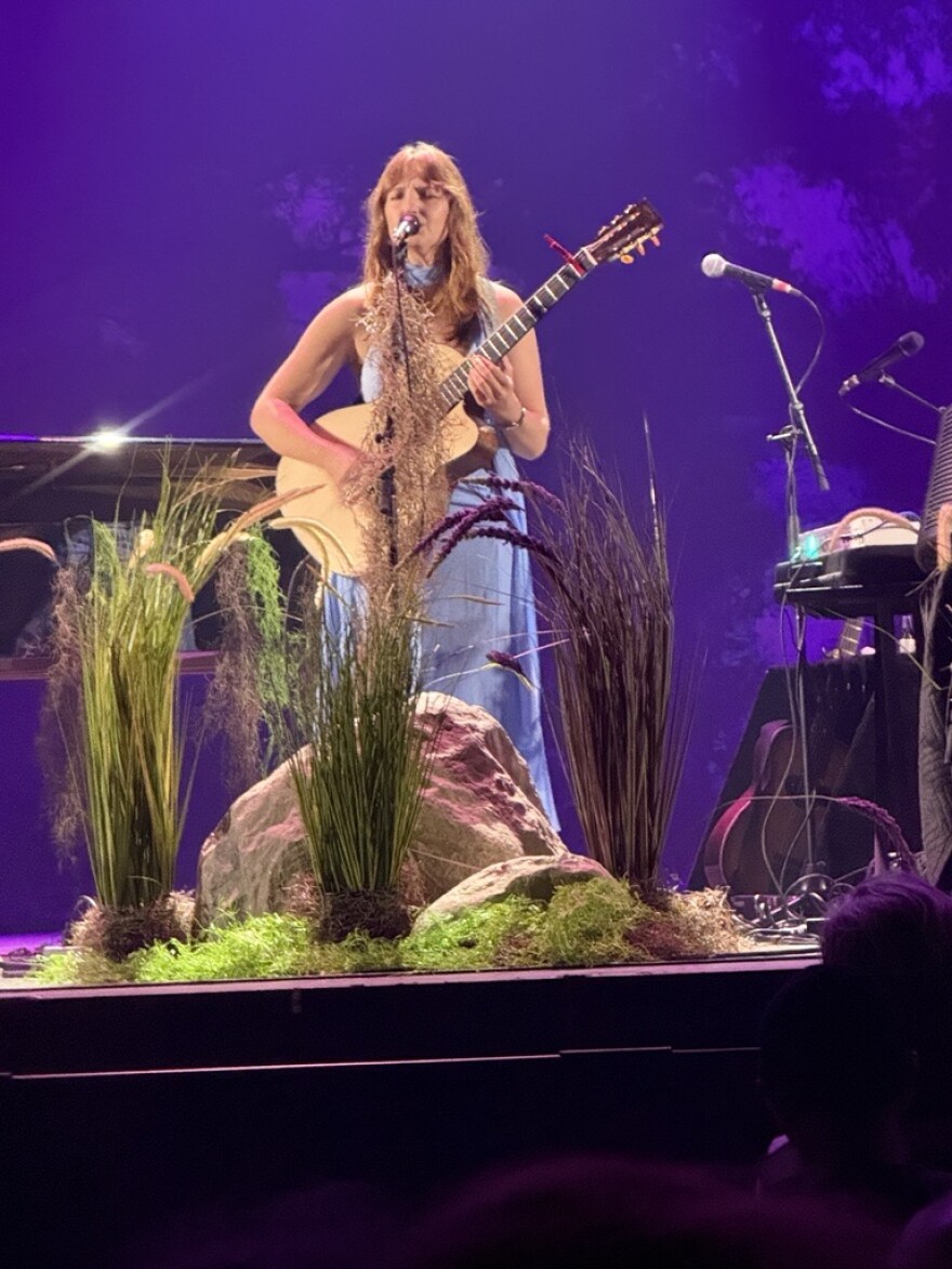 Madison Cunningham playing guitar on-stage