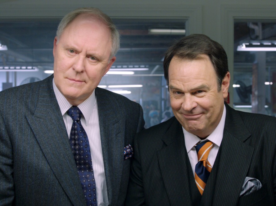 The Motch brothers (John Lithgow and Dan Aykroyd) support Huggins' campaign in hopes of securing their own business interests. The brothers' last name is a not-so-veiled reference to the real-life Koch brothers.