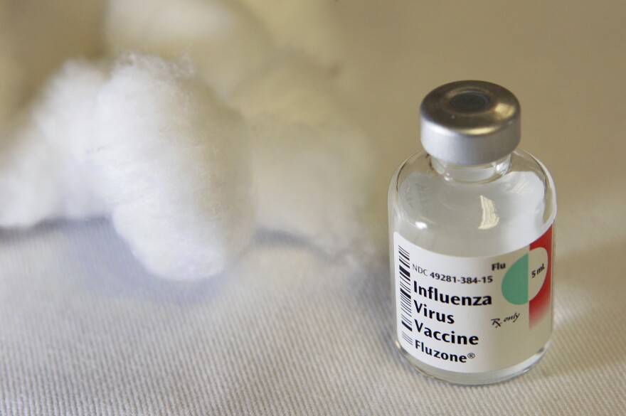 FILE: A vial that contained a dose of seasonal flu vaccine is seen on a table with cotton balls where flu shots were being administered in Boston Thursday, Oct. 1, 2009. (AP Photo/Elise Amendola)