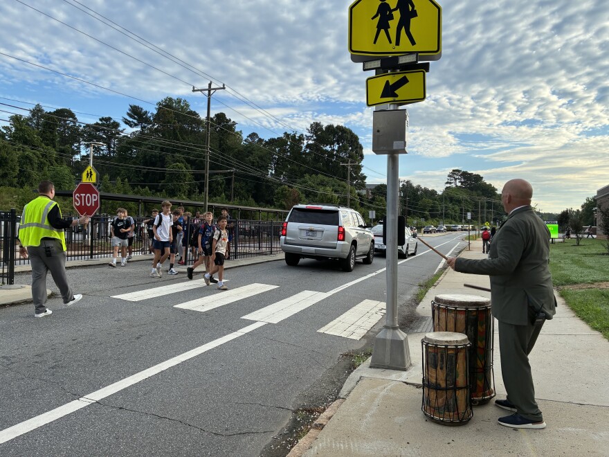 Wiley Magnet Middle School Principal Colin Tribby plays the drums to welcome students back to school