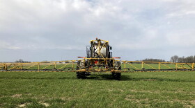 FILE - In this April 5, 2021 file photo, farmer Rick Clifton drives a spray tractor across one of his fields, applying herbicide to cover crops that occupied the ground during fall and winter in Orient, Ohio.