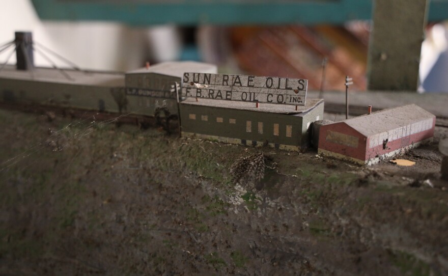 A diorama of the Genesee River gorge depicts industrial and other business operations in and along the gorge around the start of the 1900s, north of the Smith Street or Bausch Memorial Bridge in Rochester.