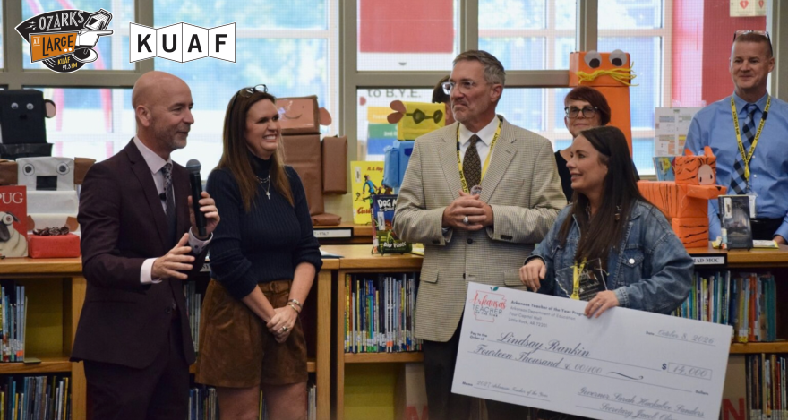 Education Secretary Jacob Oliva (left) addresses a crowd following the announcement of Lindsay Rankin (far right) as the 2027 Arkansas Teacher of the Year. Gov. Sarah Huckabee Sanders and Springdale School District Superintendent Jared Cleveland listen during the surprise ceremony at Bernice Young Elementary School on Oct. 8, 2026.