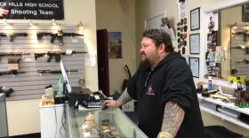 Gun dealer Don Teague behind the counter at his gun store in west Olympia. AUSTIN JENKINS / NORTHWEST NEWS NETWORK