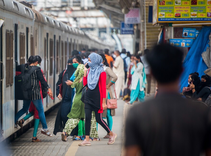 Women commuters use local trains in Mumbai. Safety on public transportation is a concern for working women.