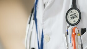 Photo of a doctor's shirt with pens in the pocket