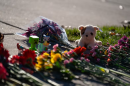 A stuffed animal and other items mark a makeshift memorial in front of Silver Rail Elementary School.