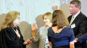 Judge Tom Jarrell (right) takes the oath of office for the NC Human Trafficking Commission in August 2018.