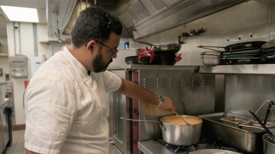 Pictured: St. Thomas Social partner and executive chef, Sunil Sharma, prepares food to distribute to SNAP beneficiaries.