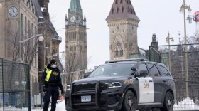 A police officer mans a checkpoint near Parliament Hill on Wednesday in Ottawa. Ottawa protesters who vowed never to give up are largely gone, chased away by police in riot gear in what was the biggest police operation in the nation's history.