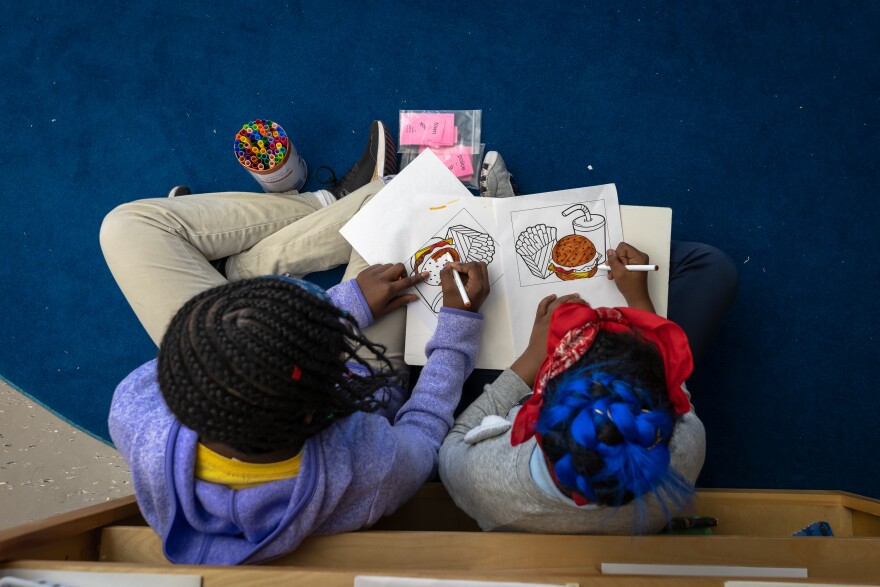 Children draw at City Garden Montessori school. The school plans to increase enrollment from 276 students to 2,500 over 10 years.