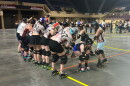 Twin Valleys Roller Derby skaters pass under a bridge made by the Carolina Bootleggers, a rival team.