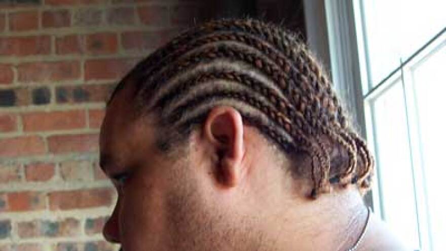 The side of someone's head with cornrows