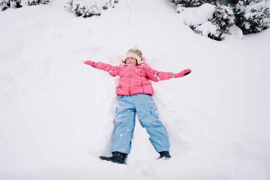 Tess Walter, 7, makes a snow angel outside of her home on Sunday, Jan. 25, 2026, in St. Louis’ Shaw neighborhood.