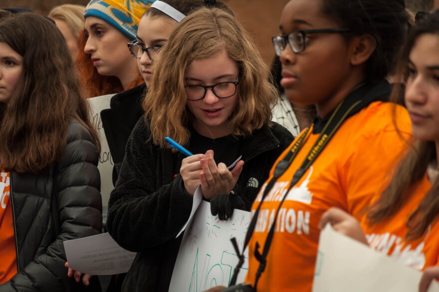 A Parkway Central High School student signs a petition calling for efforts to make schools safer during an after-school press conference Friday, Feb. 23, 2018.