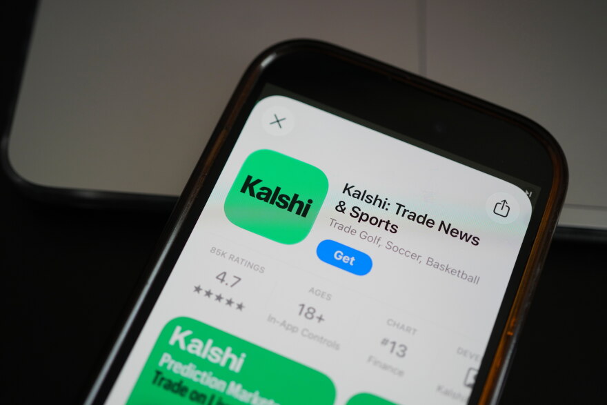An ad for the prediction market app Kalshi is displayed on a mobile phone Thursday, April 16, 2026, in Chicago. (AP Photo/Erin Hooley)