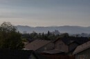 Reno Skyline with a hot air balloon next to it, houses in the foreground and the mountains in the background