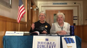 Recall Dunleavy volunteers Beverly Hoffman (left) and Kathy Hanson collect campaign signatures at the Bethel Cultural Center on Feb. 27, 2020.