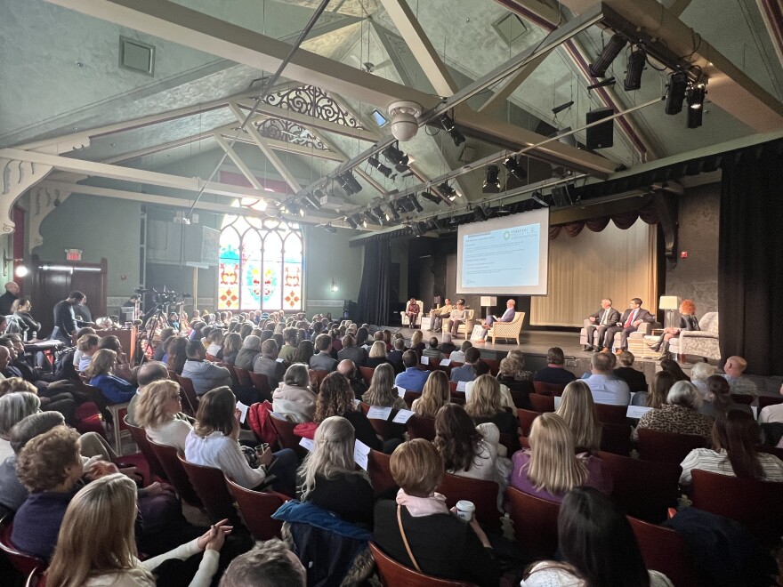 Petoskey community members and regional leaders watch a panel of interviews at the Petoskey State of the Community gathering.