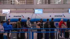 People wait in line to check in to American Airlines flights at Chicago O'Hare International Airport in Chicago, Ill., Sunday, Nov. 9, 2025.