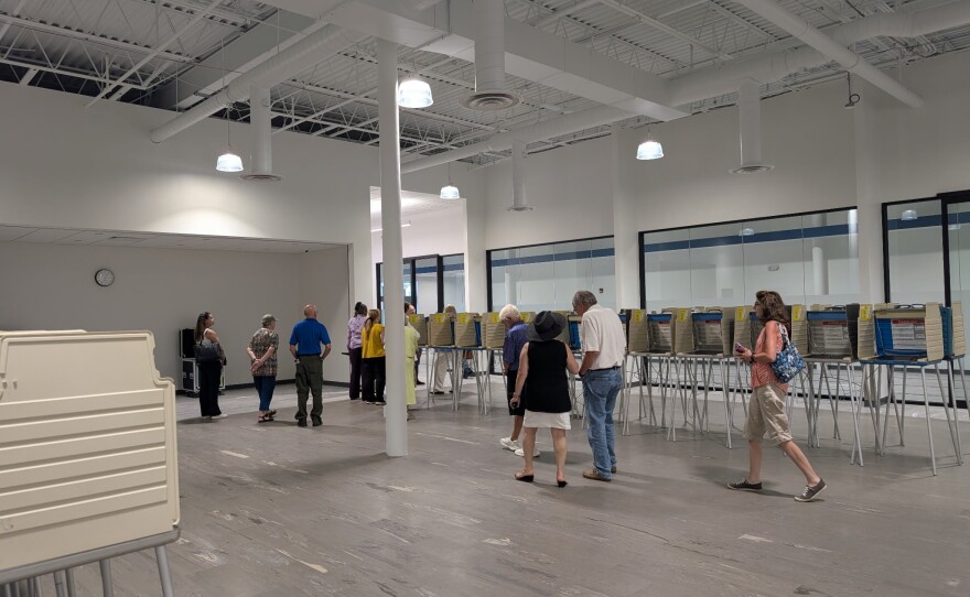 People walk past voting booths. 