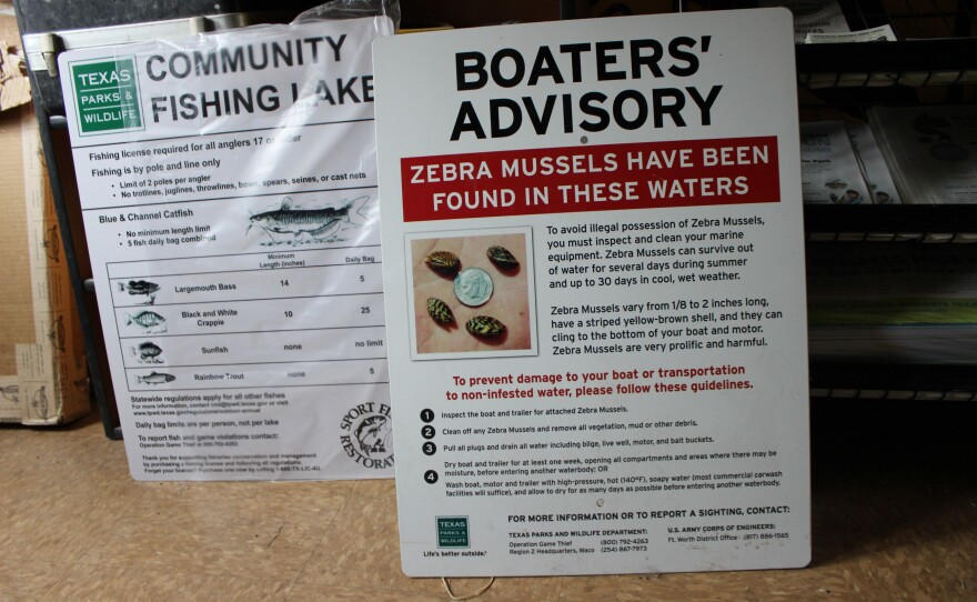 A sign warns boaters about zebra mussels, at a Texas Parks and Wildlife Office in Fort Worth.