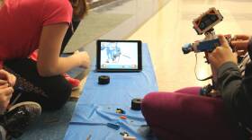 Keira Southard and two other girls work on their robot -- named A.R.C.H.E.R. -- during MakerSpace Club.