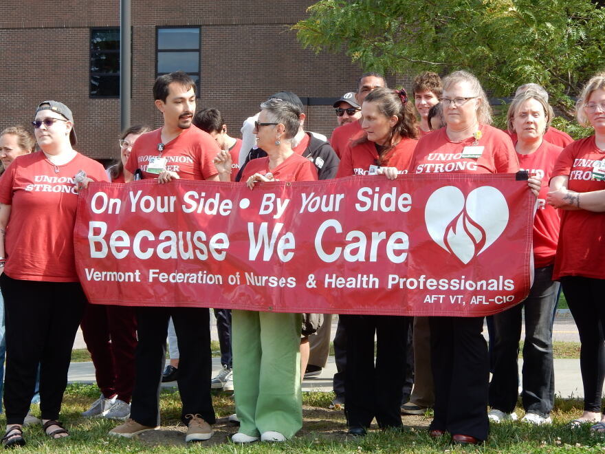 Union members at UVM Medical Center hold a banner during an AFT-VT union press conference 