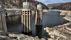 This March 26, 2019 photo shows the water level of the Colorado River, as seen from the Hoover Dam, Ariz. For the seven states that rely on the Colorado River that carries snowmelt from the Rocky Mountains to the Gulf of California, that means a future with increasingly less water for farms and cities although climate scientists say it's hard to predict how much less. The U.S. Bureau of Reclamation on Thursday, Aug. 15, 2019, will release its projections for next year's supply from Lake Mead, which feeds Nevada, Arizona and California.