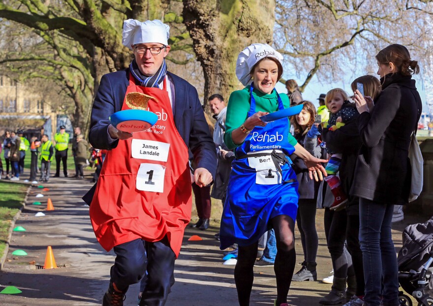 James Landale of BBC News and Baroness Bertin of the House of Lords pictured at the Rehab Parliamentary Pancake Race 2017, in which the members of Parliament's team secured victory for the second year in a row.